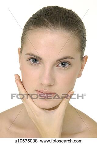 Portrait of a young woman with her hand on her chin View Large Photo Image Stock Photo - Portrait of a young woman with her hand on her chin. Fotosearch