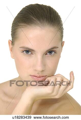 Portrait of a young woman with her hand on her chin View Large Photo Image Stock Photo - Portrait of a young woman with her hand on her chin. Fotosearch