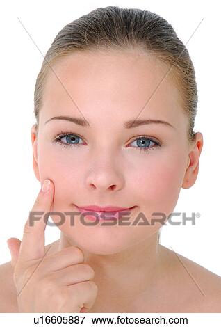 Portrait of a young woman with her finger on her cheek View Large Photo Image Stock Photo - Portrait of a young woman with her finger on her cheek. Fotosearch