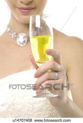 Close-up of a bride holding a champagne flute View Large Photo Image Stock Photo - Close-up of a bride holding a champagne flute. Fotosearch
