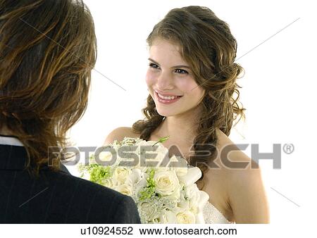 Close-up of a bride looking at her groom and smiling View Large Photo Image Stock Image - Close-up of a bride looking at her groom and smiling. Fotosearch