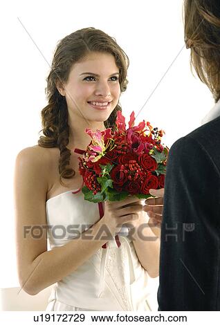 Close-up of a bride looking at her groom and smiling View Large Photo Image Stock Photo - Close-up of a bride looking at her groom and smiling. Fotosearch