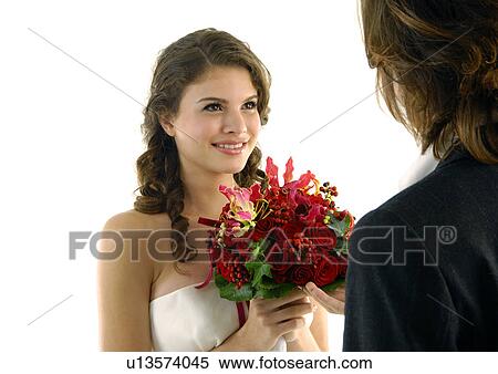 Close-up of a bride looking at her groom and smiling View Large Photo Image Stock Photography - Close-up of a bride looking at her groom and smiling. Fotosearch