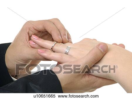 Close-up of a man putting the wedding ring on a woman's finger View Large Photo Image Stock Photography - Close-up of a man putting the wedding ring on a woman's finger. Fotosearch