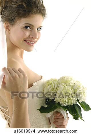 Portrait of a bride holding a bouquet of flowers View Large Photo Image Picture - Portrait of a bride holding a bouquet of flowers. Fotosearch