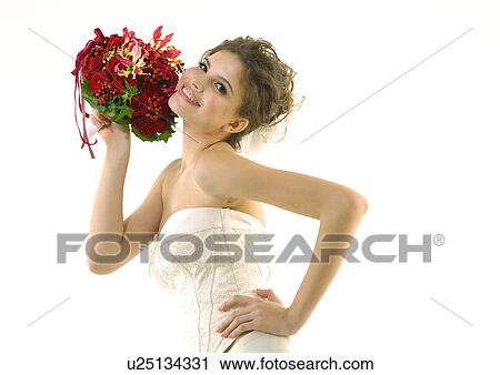 Portrait of a bride holding a bouquet of flowers and smiling View Large Photo Image Stock Image - Portrait of a bride holding a bouquet of flowers and smiling. Fotosearch