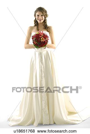 Stock Photo - Portrait of a bride holding a bouquet of flowers and smiling. Fotosearch