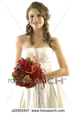 Portrait of a bride holding a bouquet of flowers and smiling View Large Photo Image Stock Photo - Portrait of a bride holding a bouquet of flowers and smiling. Fotosearch