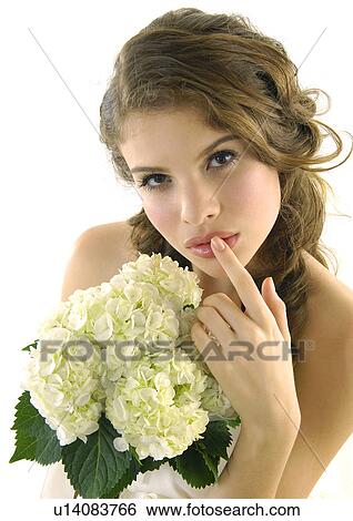 Portrait of a bride holding a bouquet of flowers View Large Photo Image Stock Photograph - Portrait of a bride holding a bouquet of flowers. Fotosearch