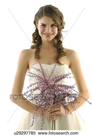 Stock Photography - Portrait of a bride holding a bouquet of flowers. Fotosearch