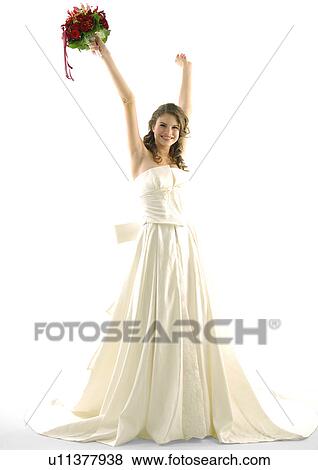 Stock Photo - Portrait of a bride raising her arms and smiling. Fotosearch