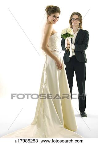 Portrait of a bride smiling with her groom standing beside her View Large Photo Image Stock Image - Portrait of a bride smiling with her groom standing beside her. Fotosearch