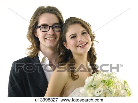 Portrait of a newlywed couple smiling View Large Photo Image Stock Photo - Portrait of a newlywed couple smiling. Fotosearch