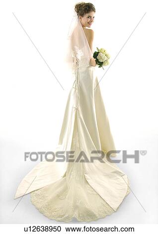 Rear view of a bride holding a bouquet of flowers and smiling View Large Photo Image Stock Image - Rear view of a bride holding a bouquet of flowers and smiling. Fotosearch