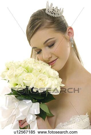 Close-up of a bride holding a bouquet of flowers View Large Photo Image Stock Photography - Close-up of a bride holding a bouquet of flowers. Fotosearch