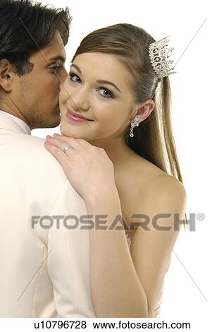 Close-up of a newlywed couple embracing each other View Large Photo Image Stock Photo - Close-up of a newlywed couple embracing each other. Fotosearch
