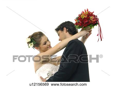 Close-up of a newlywed couple embracing each other View Large Photo Image Stock Photo - Close-up of a newlywed couple embracing each other. Fotosearch
