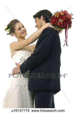 Close-up of a newlywed couple embracing each other View Large Photo Image Stock Photo - Close-up of a newlywed couple embracing each other. Fotosearch