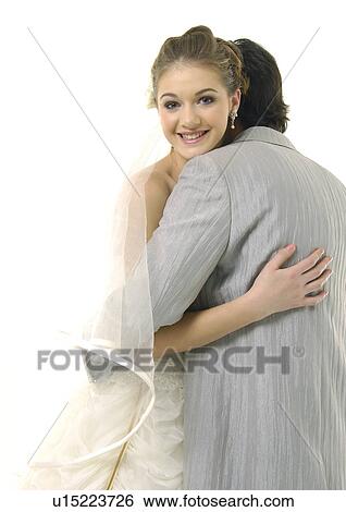 Close-up of a newlywed couple embracing each other View Large Photo Image Stock Photograph - Close-up of a newlywed couple embracing each other. Fotosearch