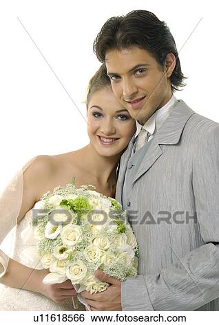 Close-up of a newlywed couple holding a bouquet of flowers View Large Photo Image Stock Photograph - Close-up of a newlywed couple holding a bouquet of flowers. Fotosearch