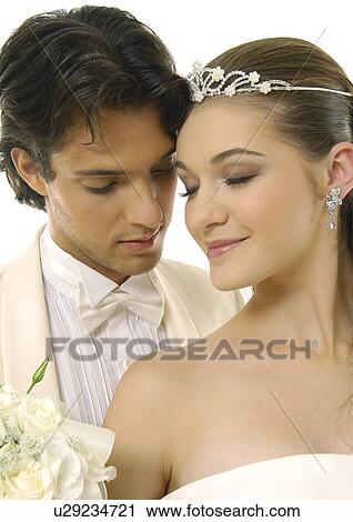 Close-up of a newlywed couple with their eyes closed View Large Photo Image Stock Image - Close-up of a newlywed couple with their eyes closed. Fotosearch
