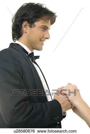 Close-up of a young man holding hands of a woman View Large Photo Image Stock Photograph - Close-up of a young man holding hands of a woman. Fotosearch