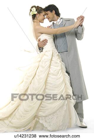 Stock Photo - Newlywed couple looking at each other and smiling. Fotosearch