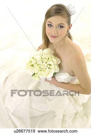Portrait of a bride holding a bouquet of flowers View Large Photo Image Stock Photo - Portrait of a bride holding a bouquet of flowers. Fotosearch