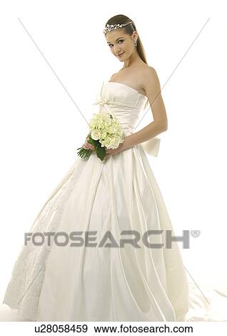 Stock Photo - Portrait of a bride holding a bouquet of flowers. Fotosearch