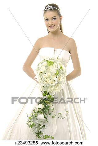 Portrait of a bride holding a bouquet of flowers View Large Photo Image Stock Photography - Portrait of a bride holding a bouquet of flowers. Fotosearch