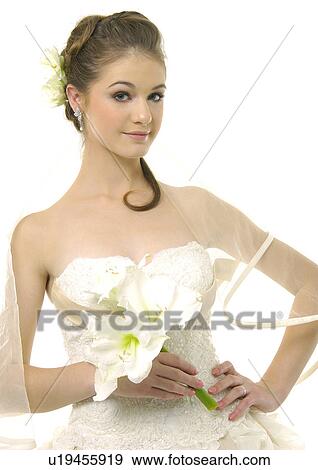Stock Photo - Portrait of a bride standing with her hand on her waist. Fotosearch