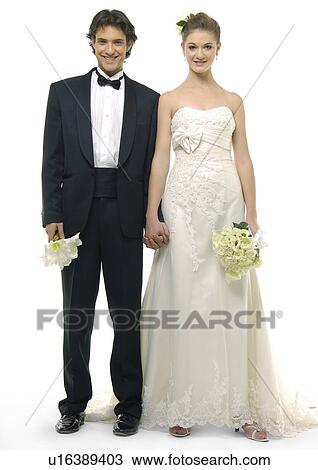 Portrait of a newlywed couple holding each other's hands and smiling View Large Photo Image Stock Image - Portrait of a newlywed couple holding each other's hands and smiling. Fotosearch