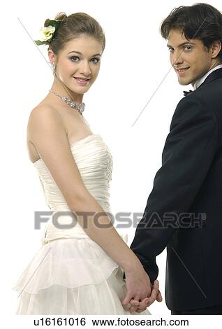 Portrait of a newlywed couple holding each other's hands and smiling View Large Photo Image Stock Photograph - Portrait of a newlywed couple holding each other's hands and smiling. Fotosearch