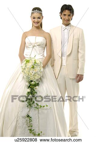 Portrait of a newlywed couple smiling and standing side by side View Large Photo Image Stock Photo - Portrait of a newlywed couple smiling and standing side by side. Fotosearch