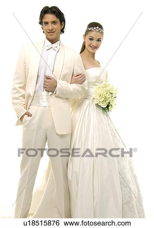 Portrait of a newlywed couple smiling and holding a bouquet of flowers View Large Photo Image Stock Photograph - Portrait of a newlywed couple smiling and holding a bouquet of flowers. Fotosearch