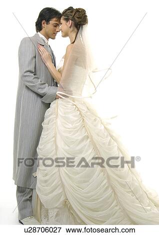 Side profile of a newlywed couple looking at each other View Large Photo Image Stock Photo - Side profile of a newlywed couple looking at each other. Fotosearch
