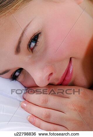 Close-up of a young woman smiling View Large Photo Image Stock Photograph - Close-up of a young woman smiling. Fotosearch