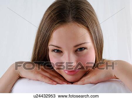 Stock Image - Portrait of a young woman smiling. Fotosearch