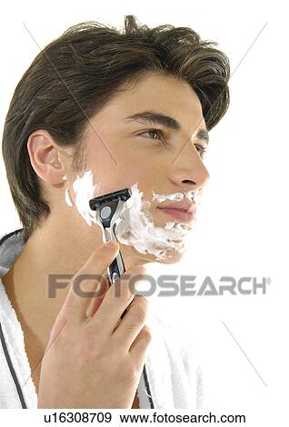 Stock Photo - Close-up of a young man shaving. Fotosearch