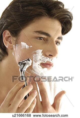 Close-up of a young man shaving View Large Photo Image Stock Photo - Close-up of a young man shaving. Fotosearch