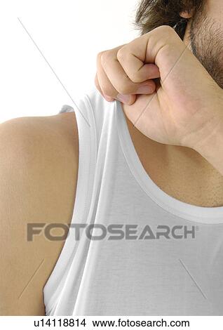 Mid section view of a man holding his vest View Large Photo Image Picture - Mid section view of a man holding his vest. Fotosearch