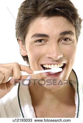 Portrait of a young man brushing his teeth View Large Photo Image Stock Image - Portrait of a young man brushing his teeth. Fotosearch