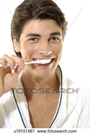 Portrait of a young man brushing his teeth View Large Photo Image Stock Image - Portrait of a young man brushing his teeth. Fotosearch