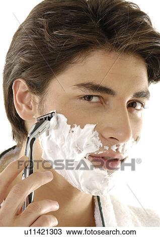 Portrait of a young man shaving View Large Photo Image Stock Image - Portrait of a young man shaving. Fotosearch