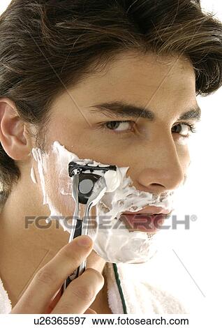 Portrait of a young man shaving View Large Photo Image Stock Photo - Portrait of a young man shaving. Fotosearch