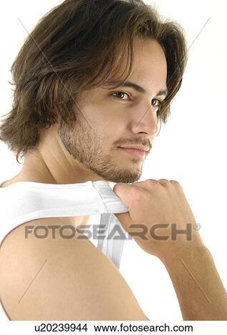 Close-up of a young man holding his vest View Large Photo Image Picture - Close-up of a young man holding his vest. Fotosearch