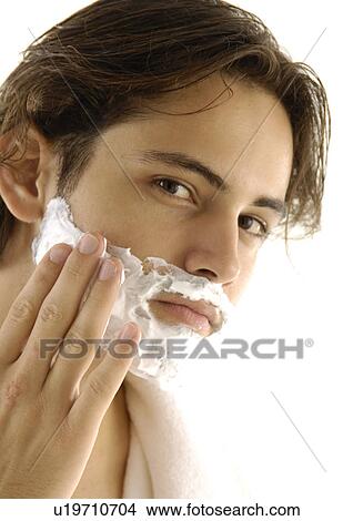 Portrait of a young man applying shaving cream View Large Photo Image Picture - Portrait of a young man applying shaving cream. Fotosearch