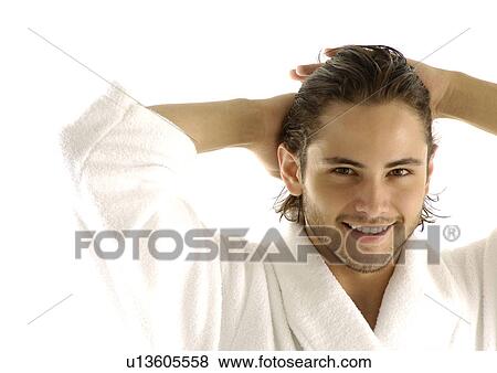 Stock Photo - Portrait of a young man smiling with his hands behind his head. Fotosearch