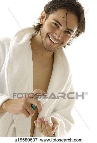Portrait of a young man squeezing shaving cream on his hand and smiling View Large Photo Image Stock Photo - Portrait of a young man squeezing shaving cream on his hand and smiling. Fotosearch
