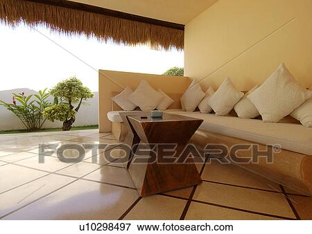 Couch with cushions in front of a coffee table View Large Photo Image Stock Photo - Couch with cushions in front of a coffee table. Fotosearch